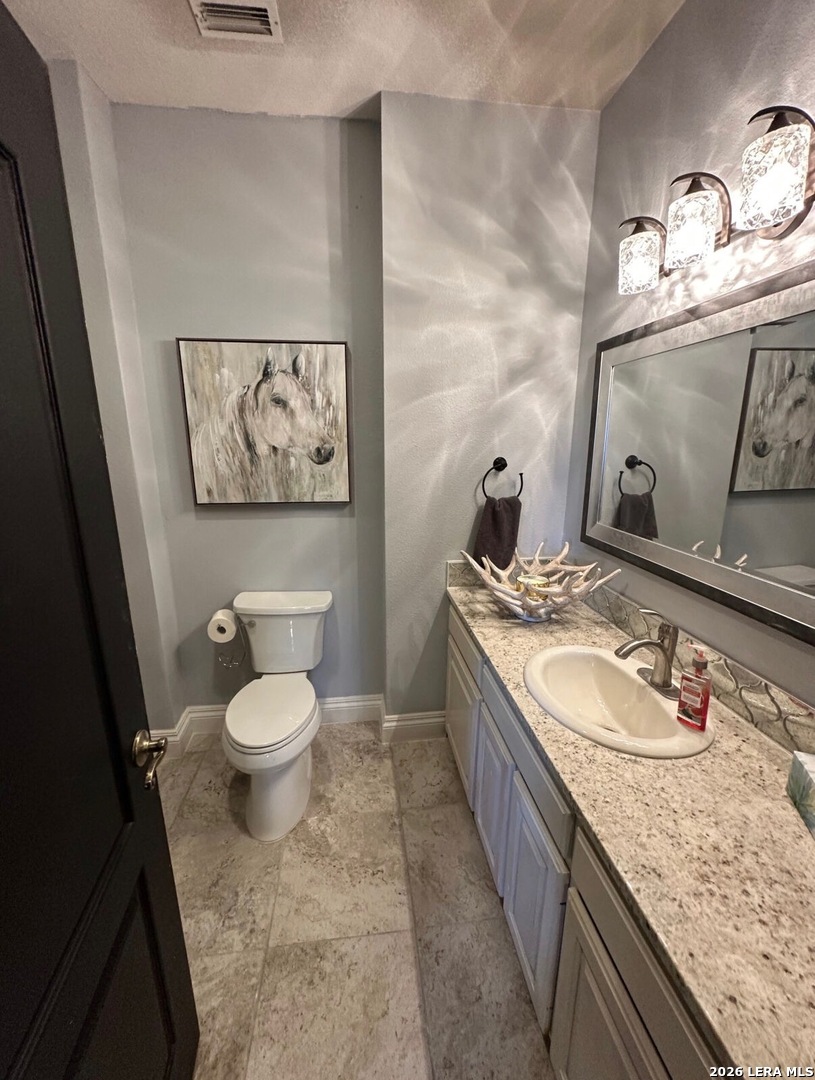 359 Park Ridge Boerne, TX 78006 - Photo 7 of 10 a bathroom with a granite countertop toilet sink and mirror