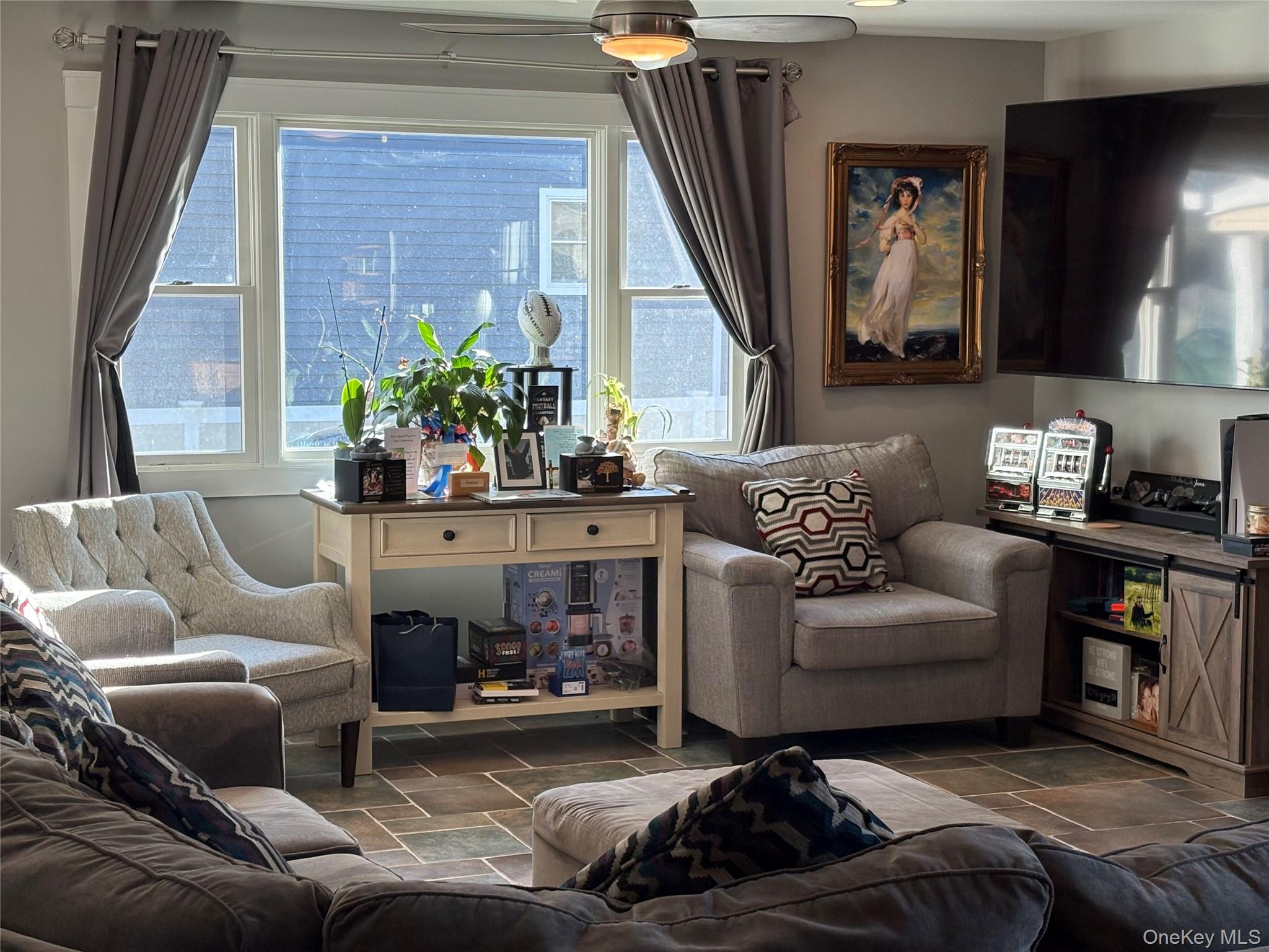 40 Alton Road Babylon, NY 11702 - Photo 15 of 41 Living room featuring healthy amount of natural light and stone tile flooring