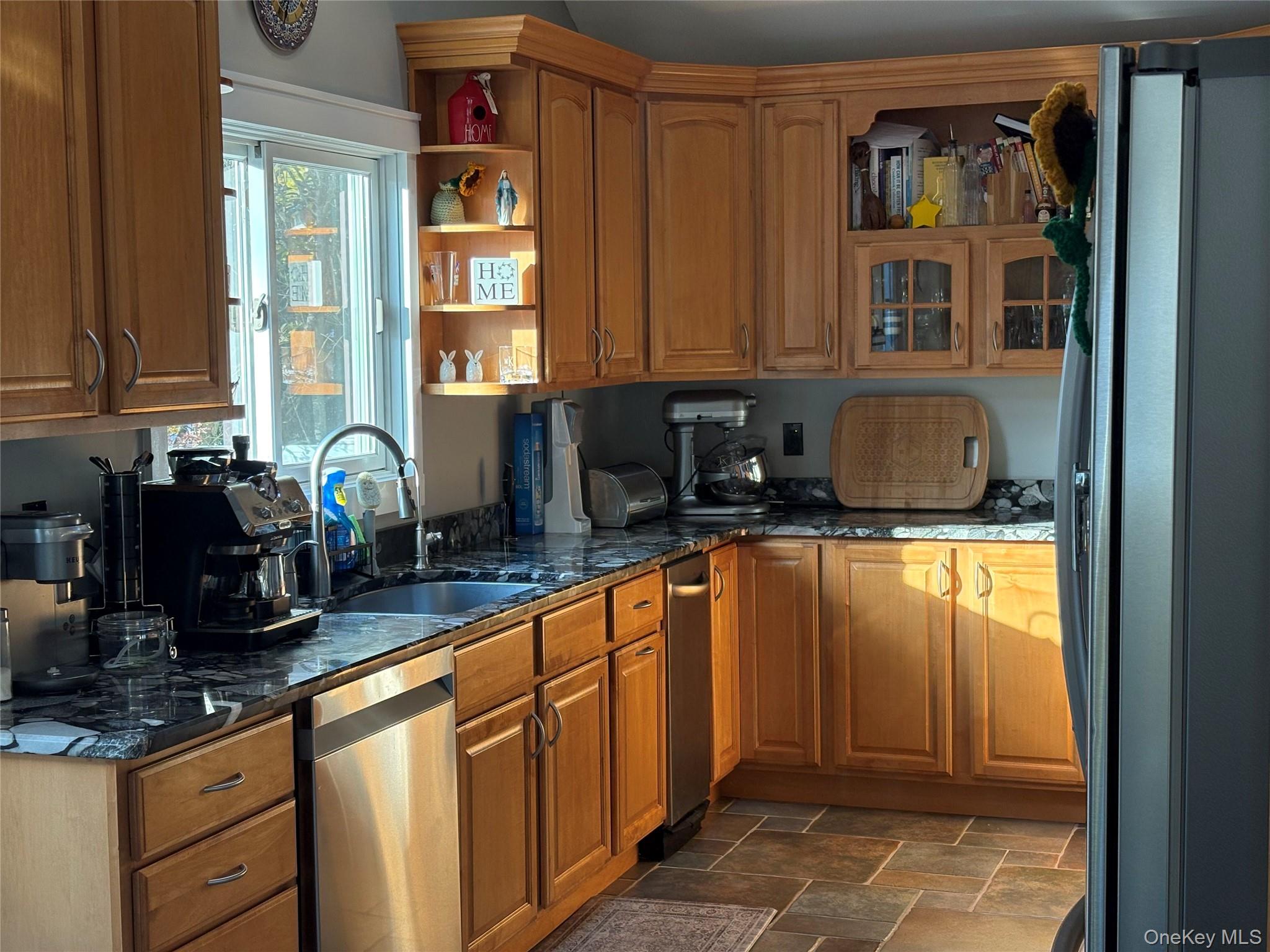 40 Alton Road Babylon, NY 11702 - Photo 19 of 41 Kitchen featuring brown cabinets, dark stone countertops, stainless steel appliances, and open shelves