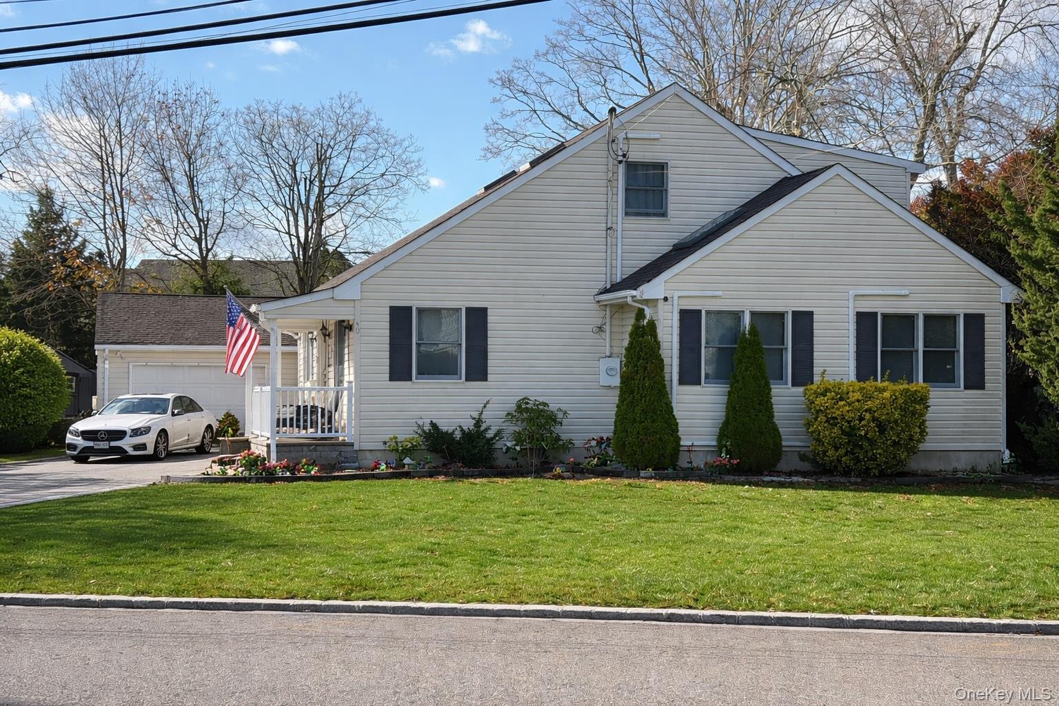 40 Alton Road Babylon, NY 11702 - Photo 2 of 41 Charming Cape Cod featuring a front lawn, covered porch, and a 1 1/2 car garage