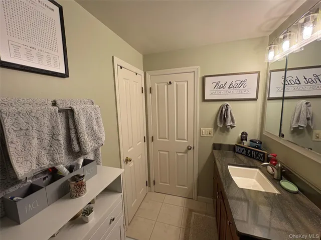 a view of a kitchen with stainless steel appliances granite countertop a sink a refrigerator and a stove top oven