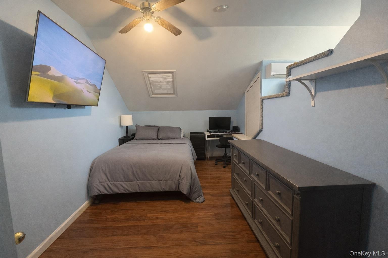 40 Alton Road Babylon, NY 11702 - Photo 26 of 41 Bedroom with an office area, vaulted ceiling, dark wood-type flooring, a ceiling fan, and a wall mounted air conditioner