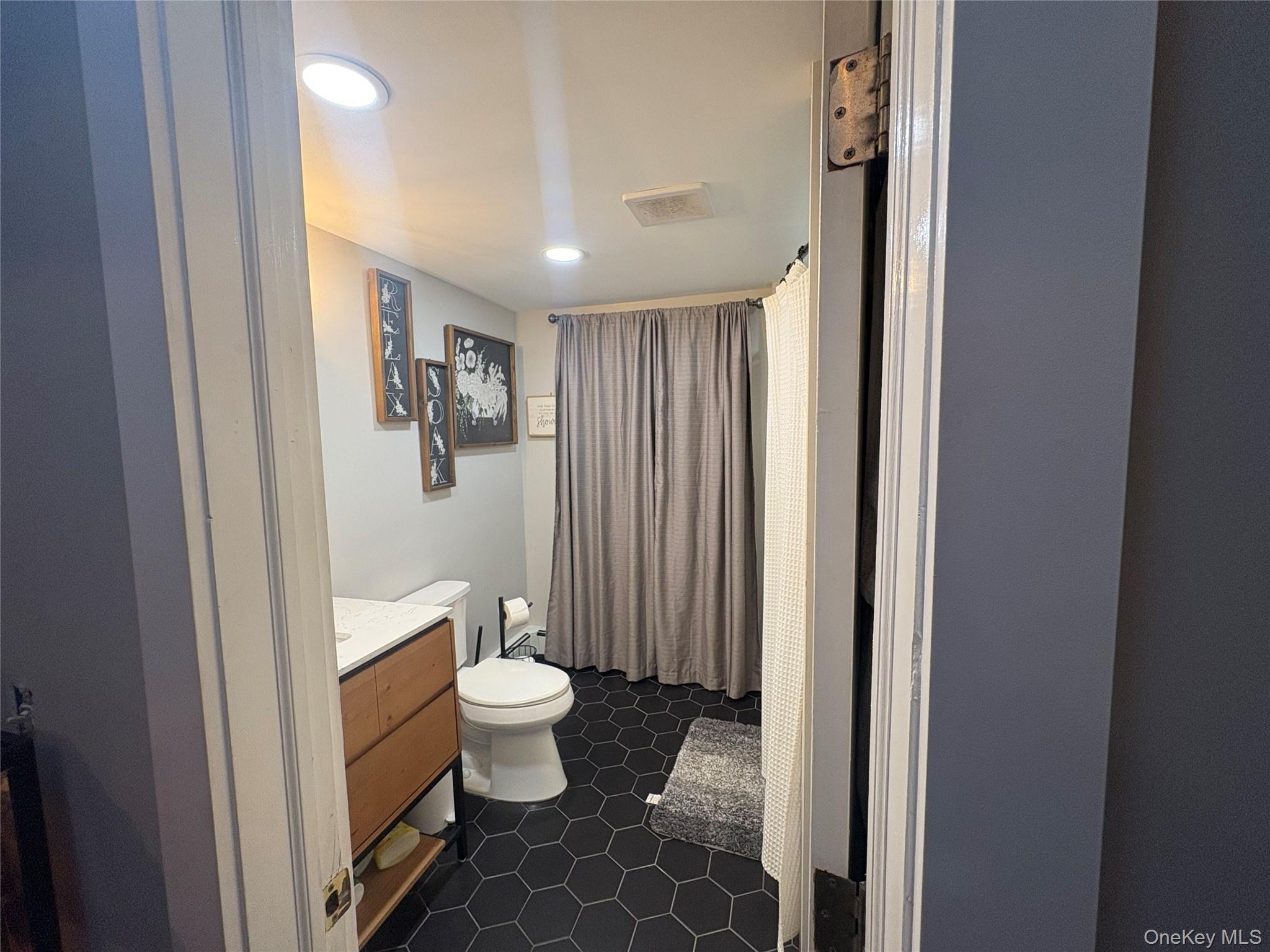 40 Alton Road Babylon, NY 11702 - Photo 30 of 41 Upstairs bathroom featuring a shower with shower curtain, vanity, recessed lighting, and dark tile patterned flooring
