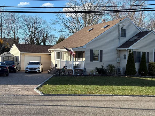 a view of a house with a big yard and potted plants