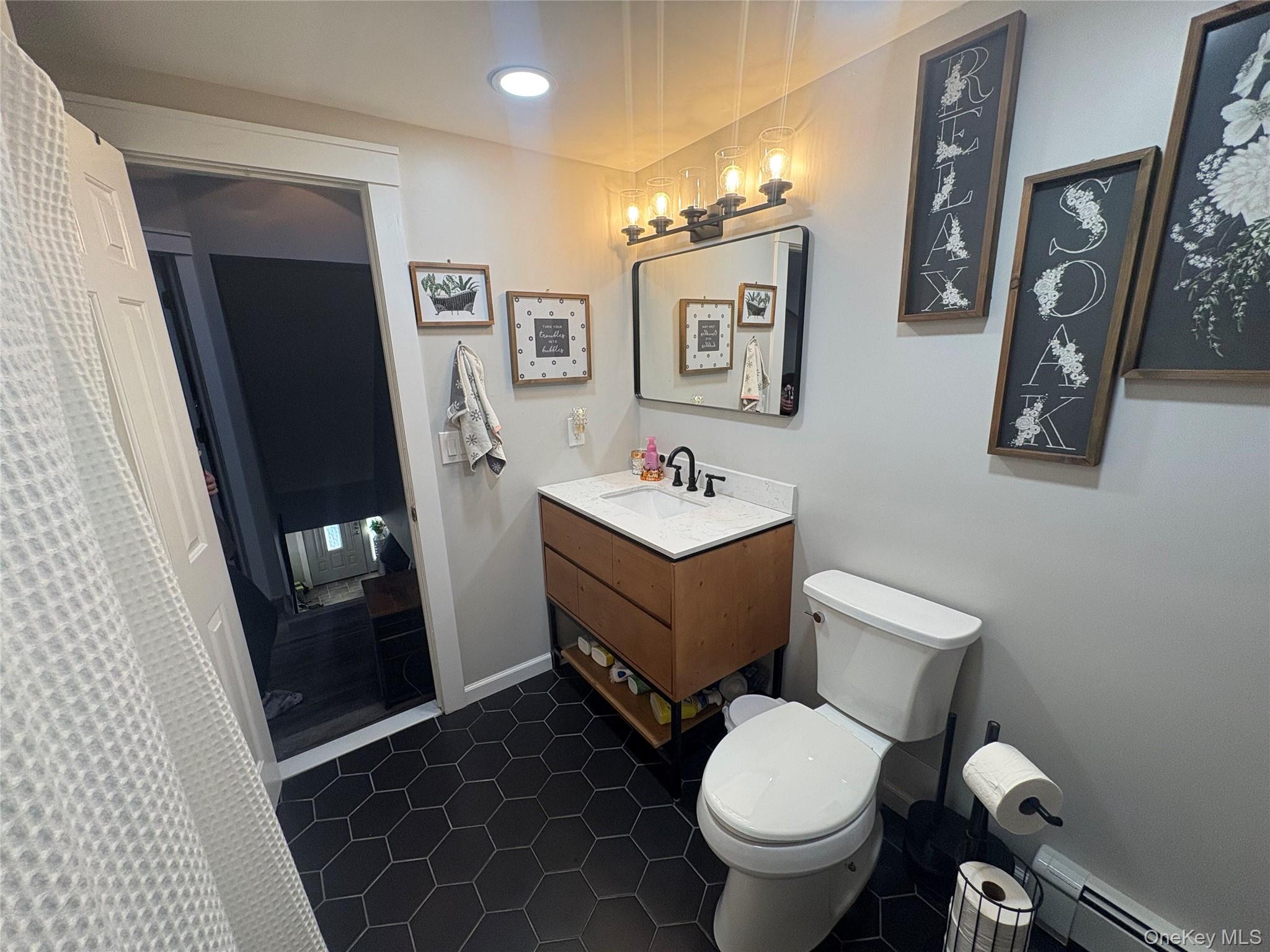 40 Alton Road Babylon, NY 11702 - Photo 33 of 41 Full bath with baseboard heating, vanity, a shower with curtain, dark tile patterned floors, and recessed lighting