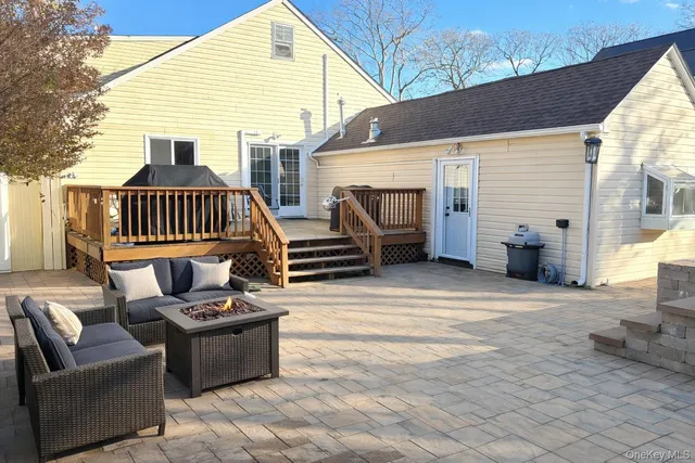 a view of house with backyard and sitting area