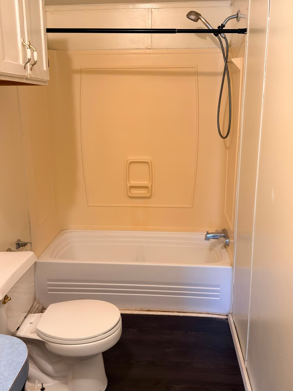 8607 Burleson Manor Road, Unit A Manor, TX 78653 - Photo 7 of 13 A well-maintained tub and shower combination with a handheld showerhead awaits in this practical bathroom.