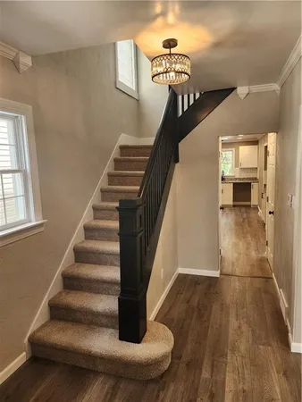 a view of entryway and hall with wooden floor