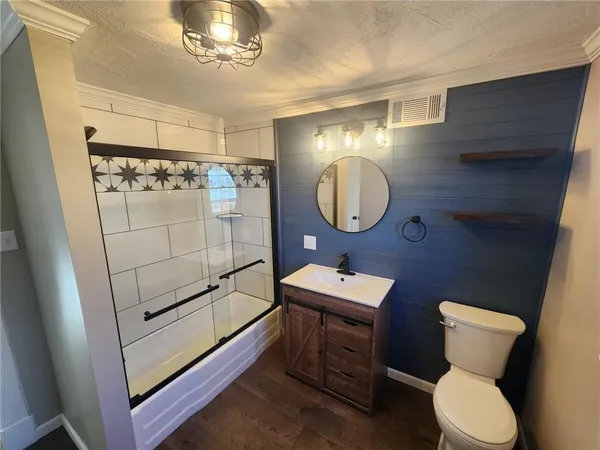 a bathroom with a toilet a sink and mirror