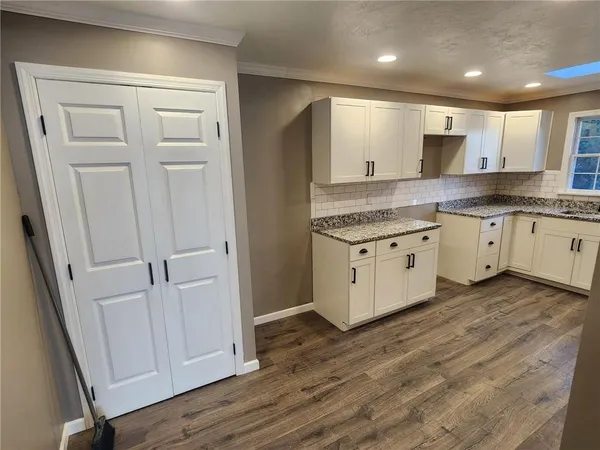 a kitchen with white cabinets