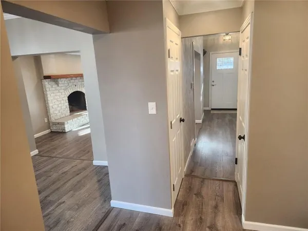 a view of a hallway with wooden floor