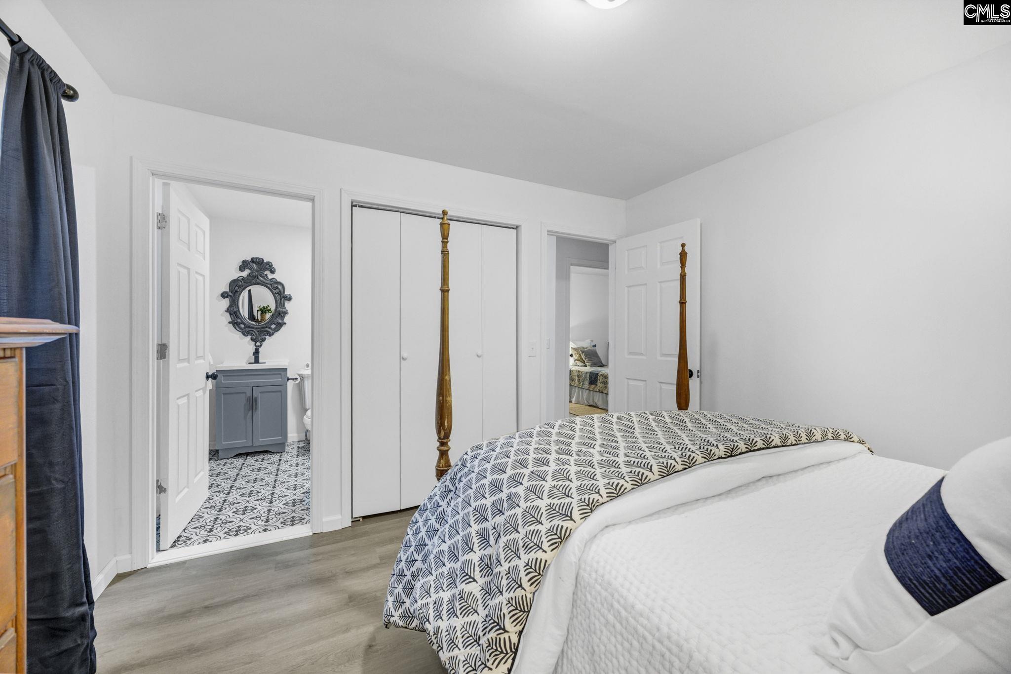8107 Black River Road Rembert, SC 29128 - Photo 19 of 38 a bedroom with a bed and a chandelier