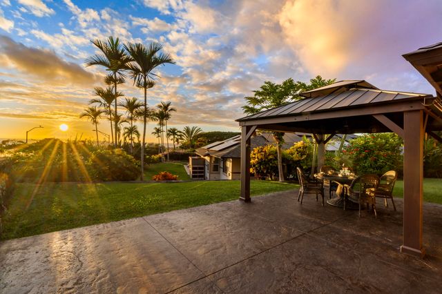 a view of group of people sitting on a bench in front of house