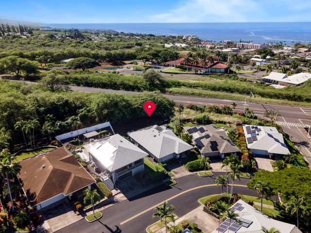 an aerial view of a houses with a swimming pool