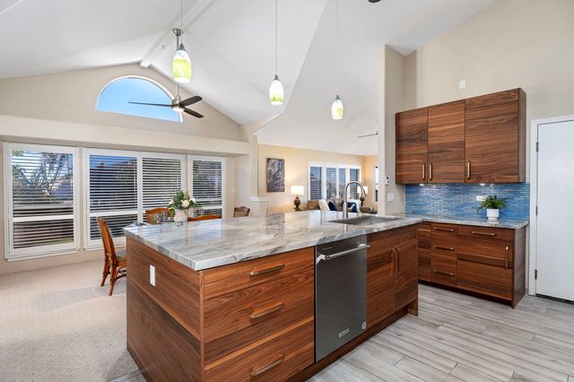 a kitchen with stainless steel appliances granite countertop a stove and a sink