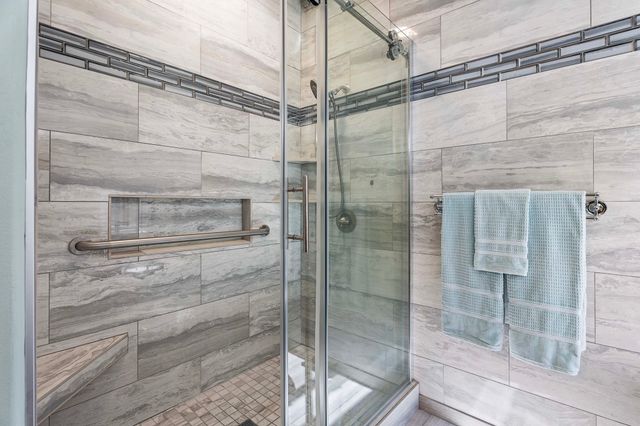 a bathroom with a glass shower door