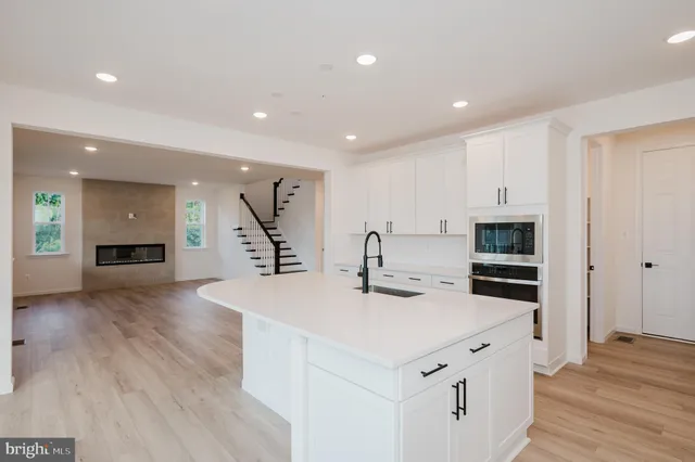 a view of a kitchen with a sink and a living room view