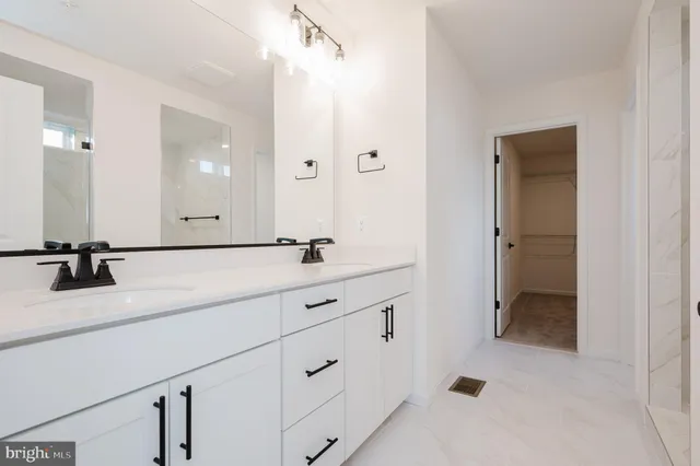 a bathroom with a double vanity sink and mirror