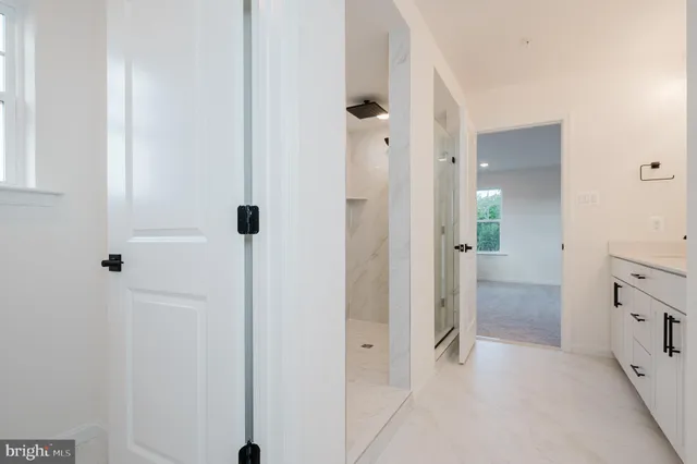 view of a bathroom with a shower and a sink
