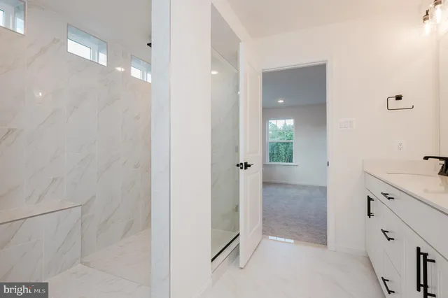 a bathroom with a shower sink and mirror