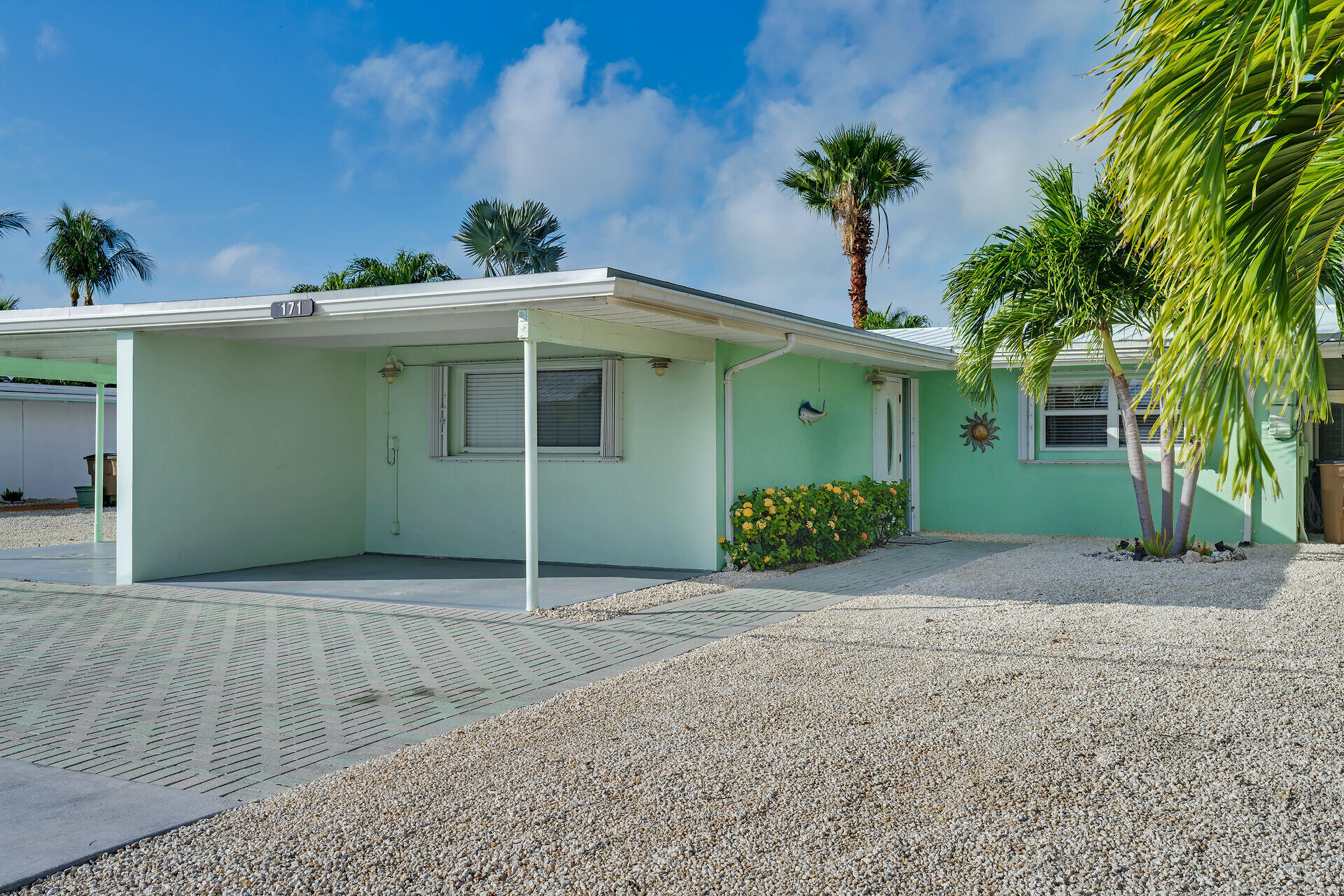 171 10th Street Key Colony Beach, FL 33051 - Photo 7 of 56 a front view of a house with plants