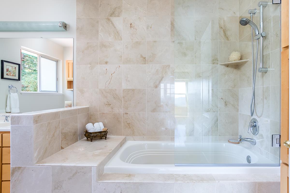 377 Rider Ridge Road Santa Cruz, CA 95065 - Photo 12 of 25 a bath tub sitting next to a white sink and vanity