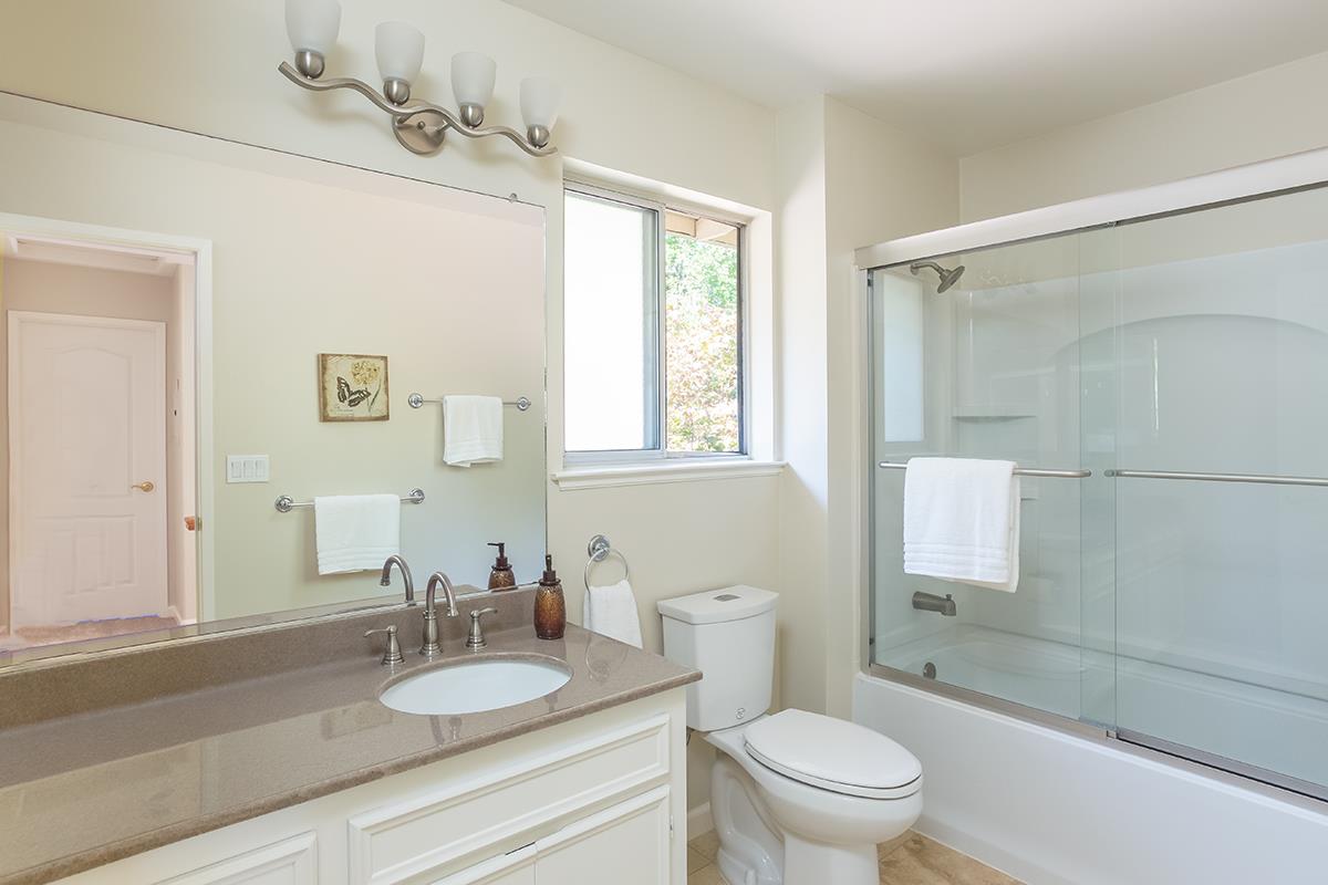 377 Rider Ridge Road Santa Cruz, CA 95065 - Photo 15 of 25 a bathroom with a granite countertop sink toilet a mirror and shower