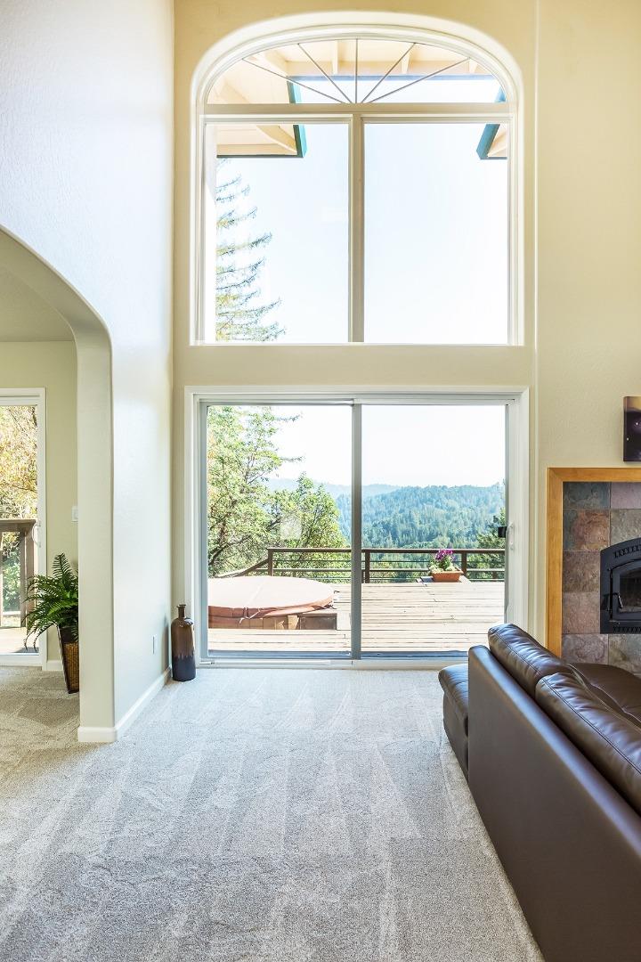 377 Rider Ridge Road Santa Cruz, CA 95065 - Photo 4 of 25 a view of an empty room with a fireplace and a window