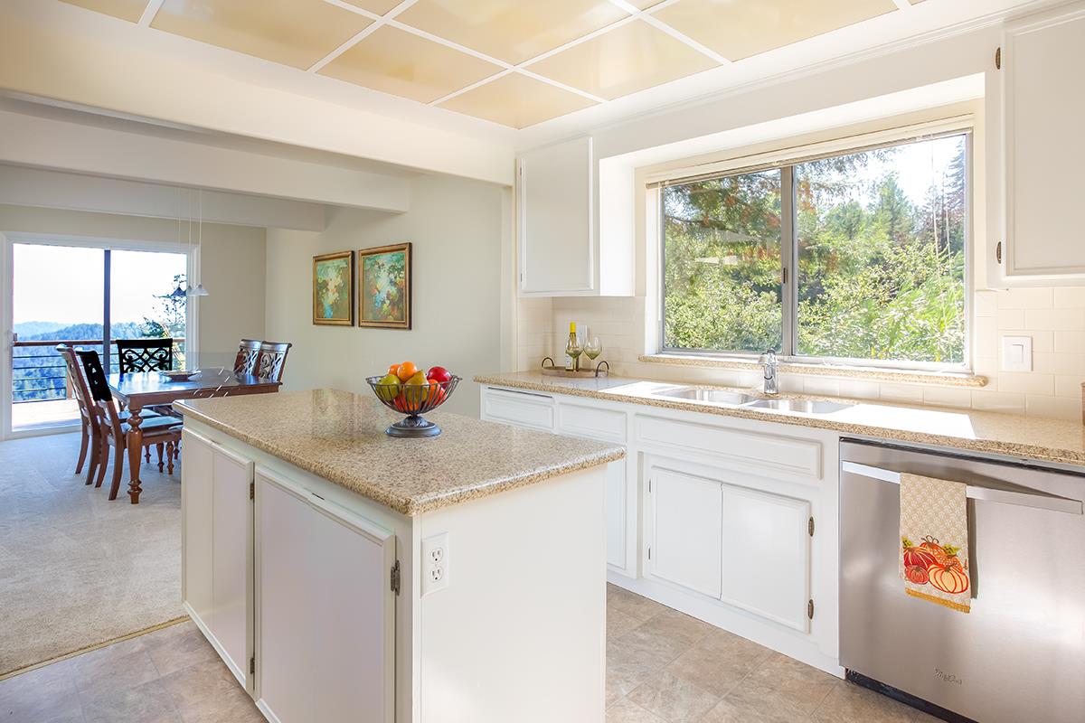 377 Rider Ridge Road Santa Cruz, CA 95065 - Photo 8 of 25 a kitchen with sink cabinets and table