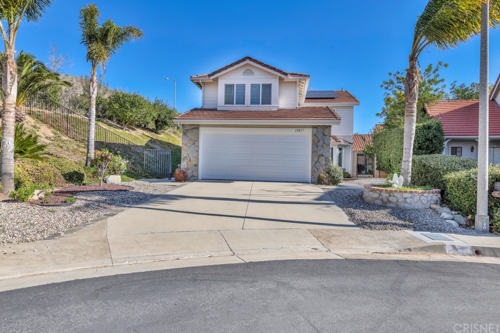 19857 Crystal Ridge Lane Porter Ranch, CA 91326 - Photo 1 of 1 a front view of a house with a garden