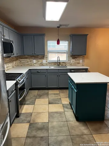 a kitchen with stainless steel appliances granite countertop a stove and a sink