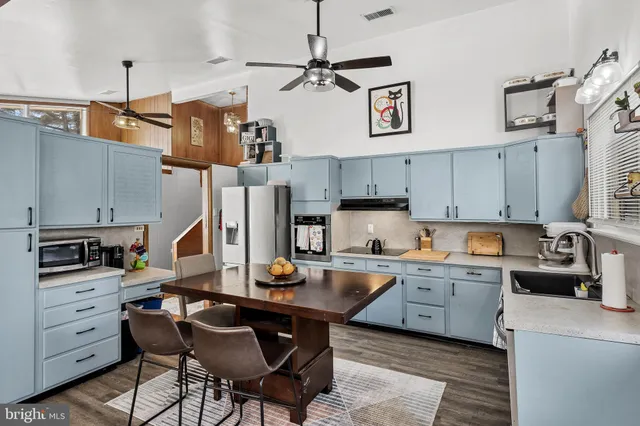 a kitchen with cabinets a sink and appliances