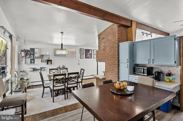 a view of a dining room with furniture and wooden floor
