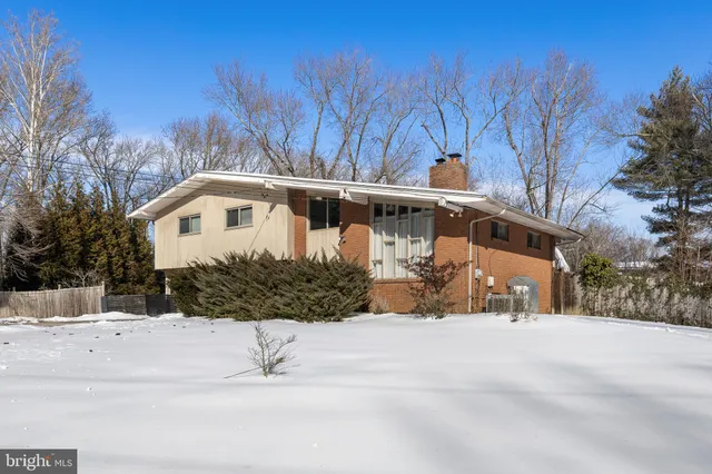 a view of a white house with a yard