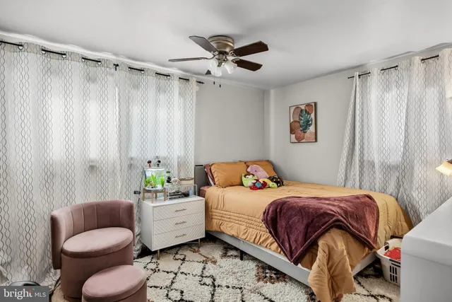 a bedroom with a bed and a couch