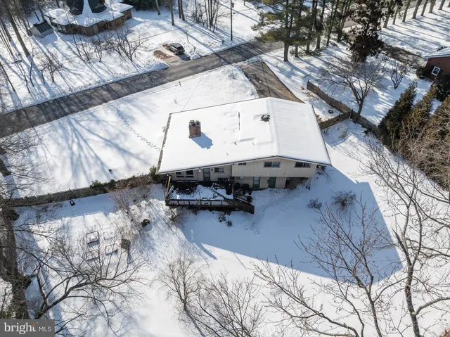 a view of a patio with table and chairs under an umbrella