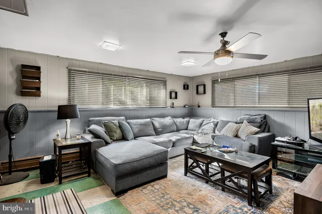 a living room with furniture a rug and a window