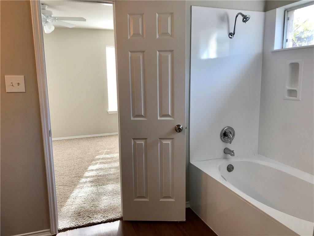 1251 Pine Portage Loop Leander, TX 78641 - Photo 14 of 17 a bathroom with a bathtub and shower