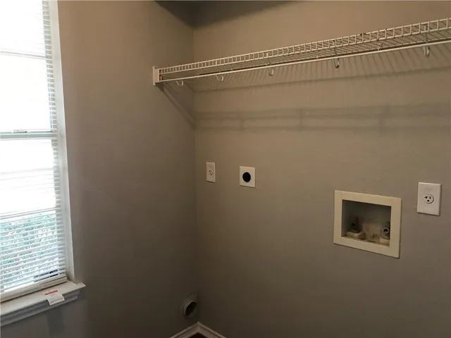 a bathroom with a shower and a window