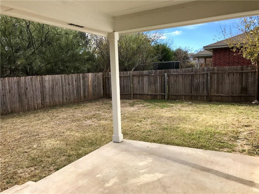 1251 Pine Portage Loop Leander, TX 78641 - Photo 17 of 17 a view of a backyard with wooden fence