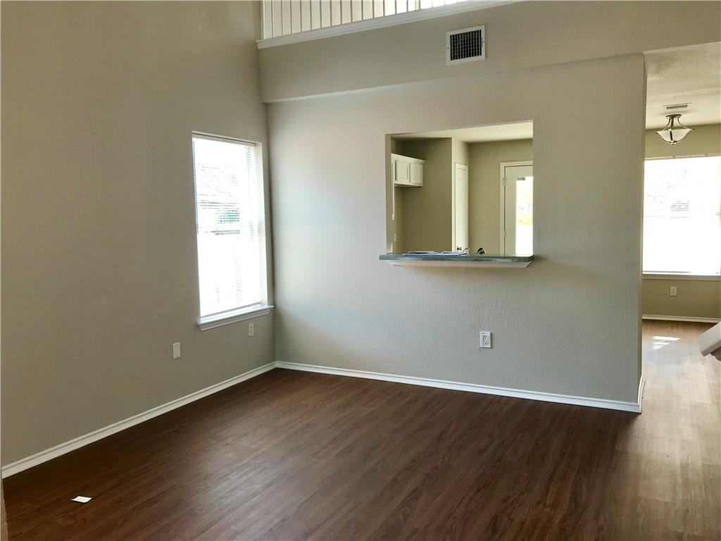1251 Pine Portage Loop Leander, TX 78641 - Photo 3 of 17 an empty room with wooden floor and windows