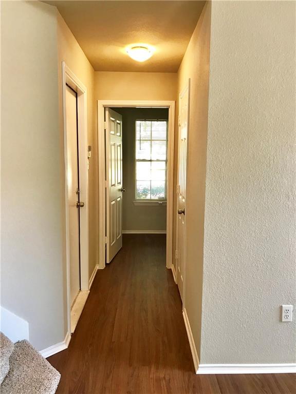 1251 Pine Portage Loop Leander, TX 78641 - Photo 4 of 17 a view of a hallway with wooden floor and a bathroom