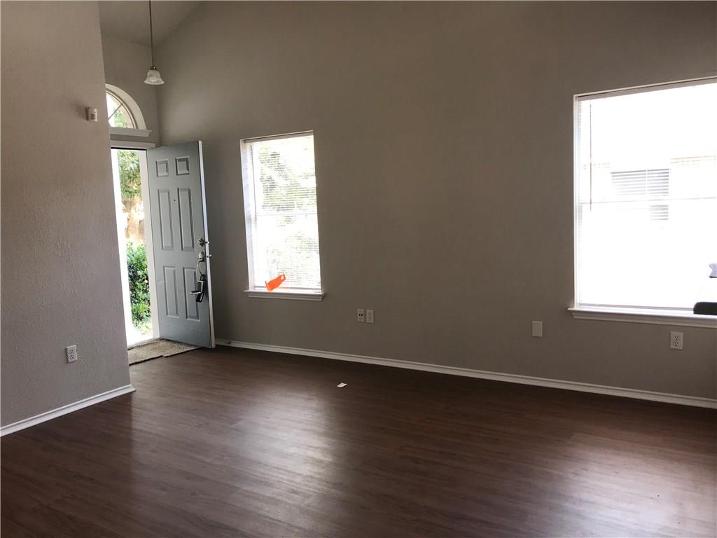 1251 Pine Portage Loop Leander, TX 78641 - Photo 10 of 17 an empty room with wooden floor and windows