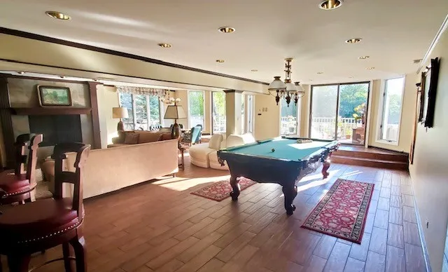 a living room with furniture and a pool table