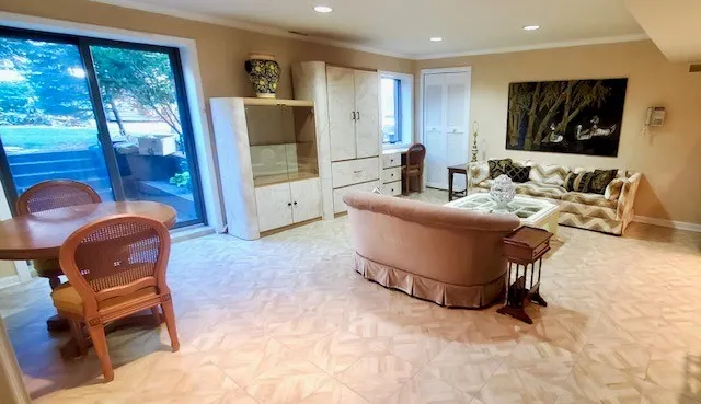 a view of a dining room with furniture floor to ceiling window and wooden floor