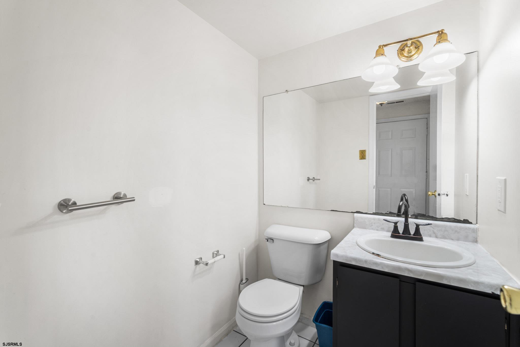 718 Cardinal Way Galloway Township, NJ 08205 - Photo 13 of 25 a bathroom with a sink a toilet and a mirror