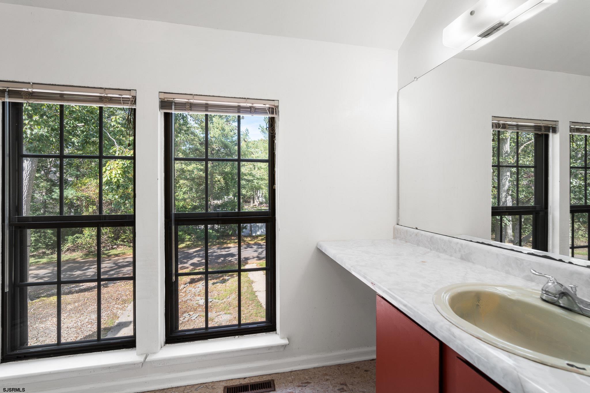 718 Cardinal Way Galloway Township, NJ 08205 - Photo 17 of 25 a bathroom with a granite countertop sink and a window