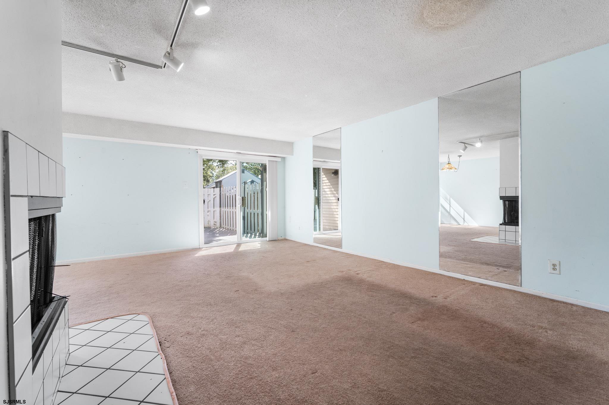718 Cardinal Way Galloway Township, NJ 08205 - Photo 6 of 25 a view of a big room with windows and brick walls