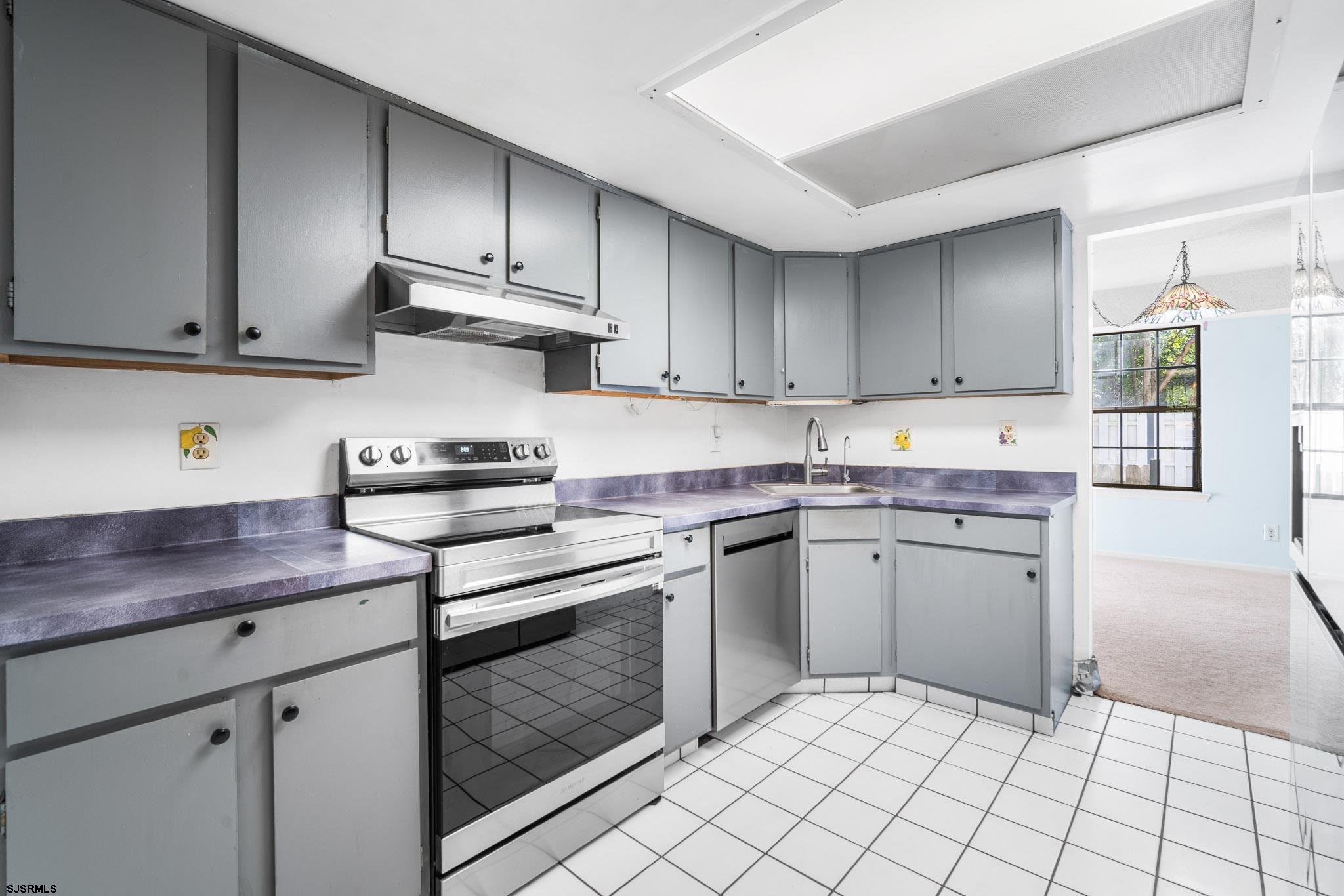 718 Cardinal Way Galloway Township, NJ 08205 - Photo 9 of 25 a kitchen with cabinets appliances and a sink