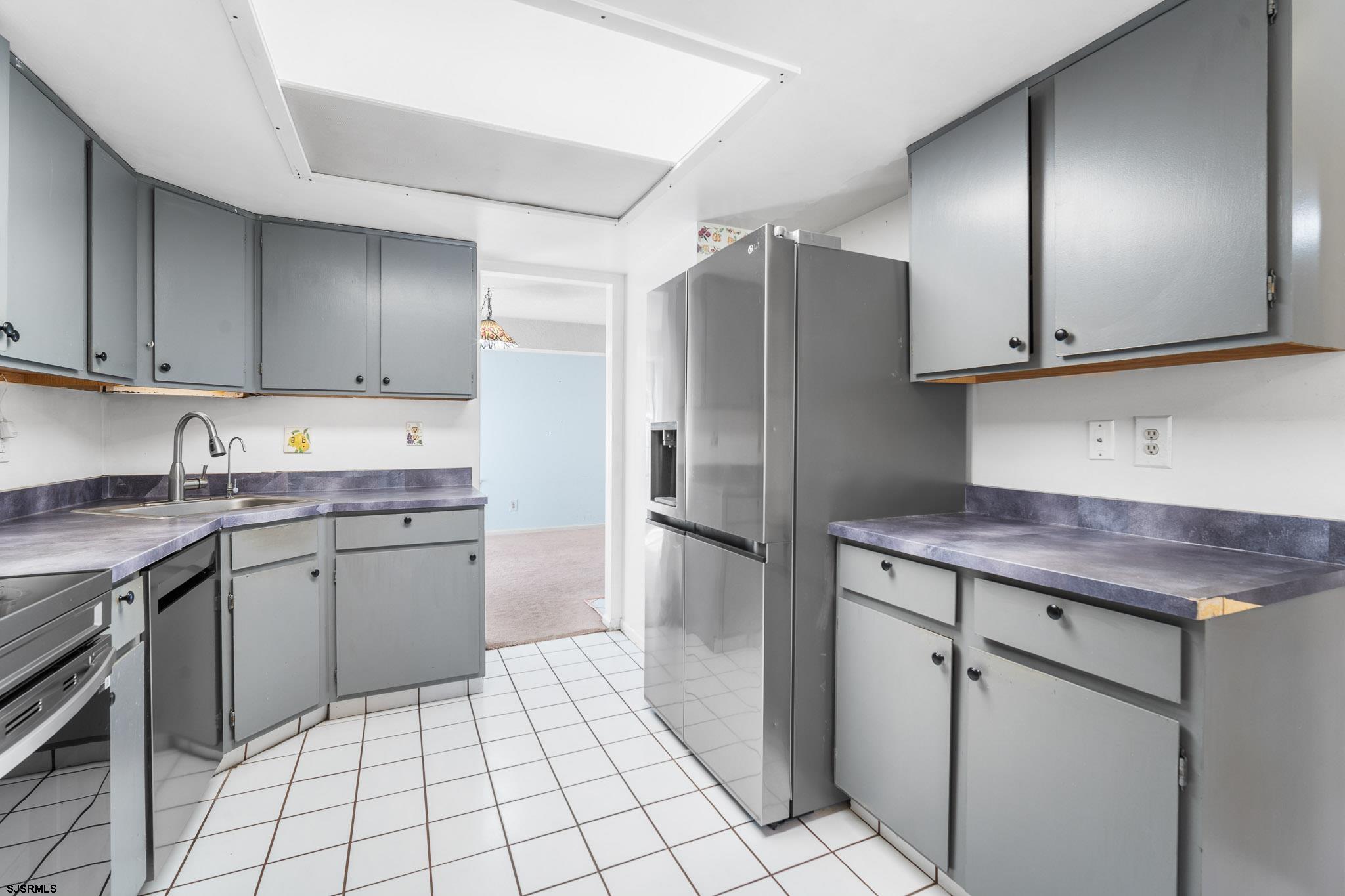 718 Cardinal Way Galloway Township, NJ 08205 - Photo 10 of 25 a kitchen with a refrigerator sink and cabinets